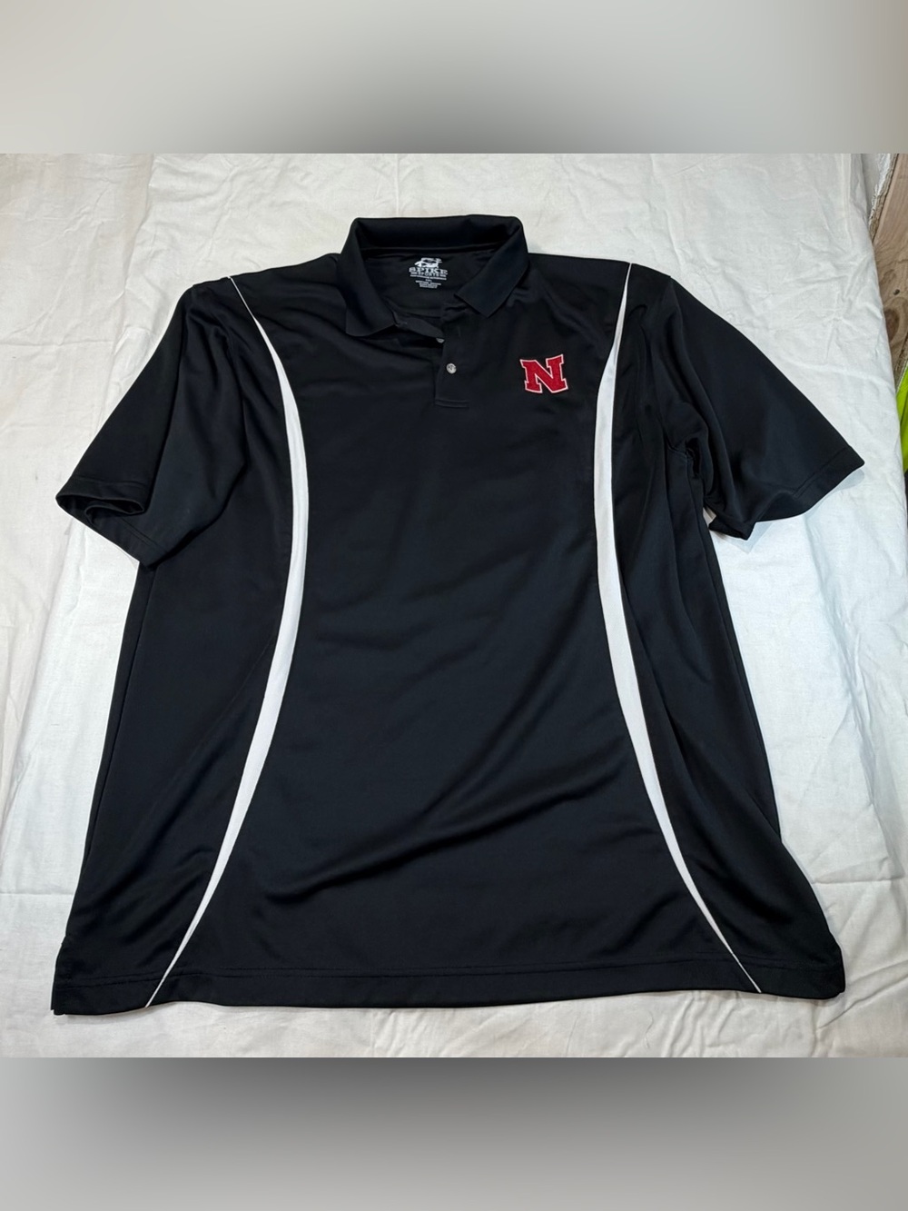 Spike Sports Men's Black Polo with White Accents and Nebraska Huskers logo
